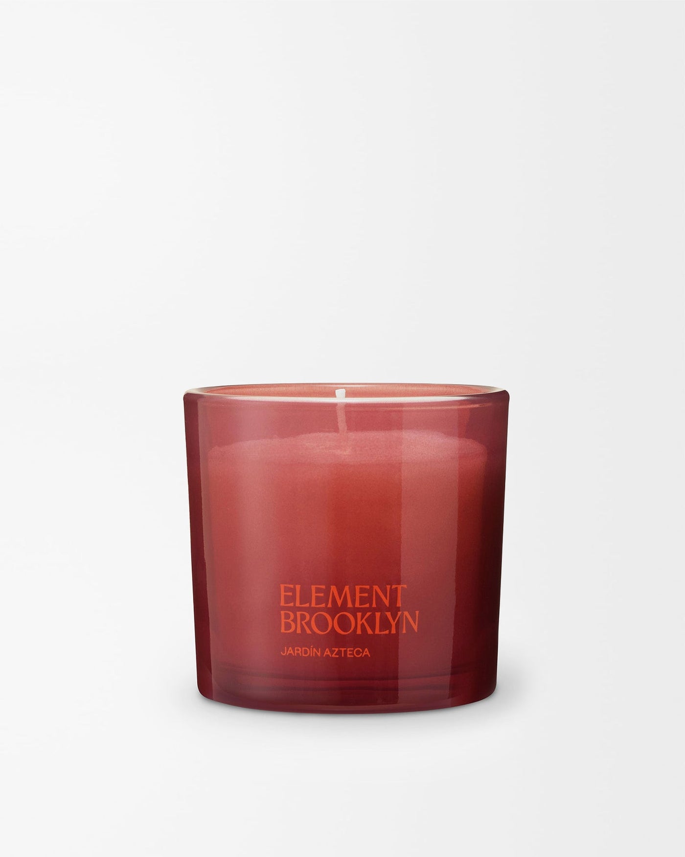 Jardín Azteca soy candle by Element Brooklyn in a deep red glass vessel on a white background