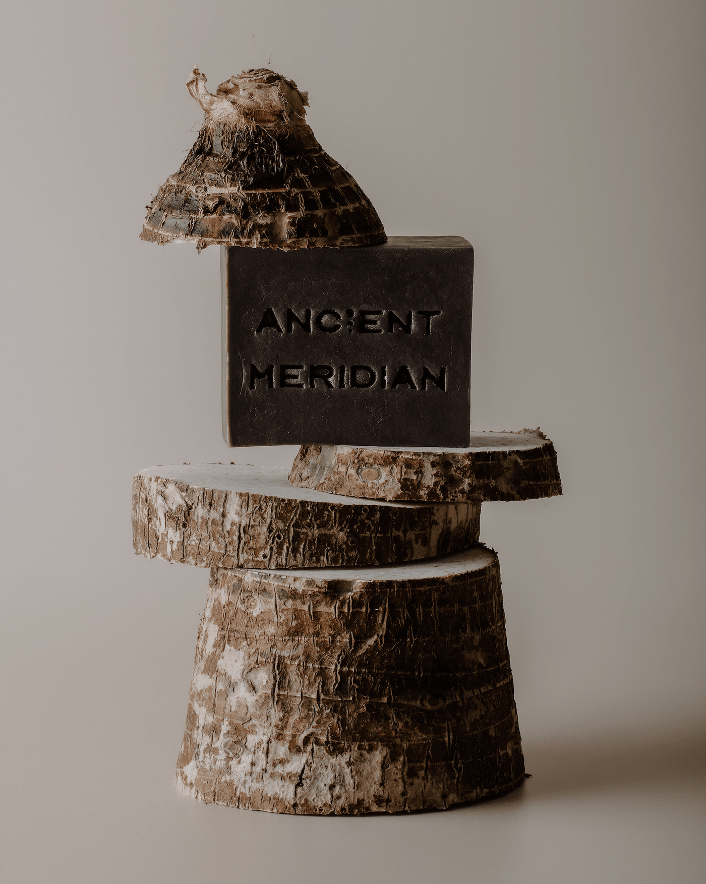 Ancient Meridian Sadaa coffee soap brick styled on natural surface – energizing exfoliating bar soap with orange peel and musk, Here & Always