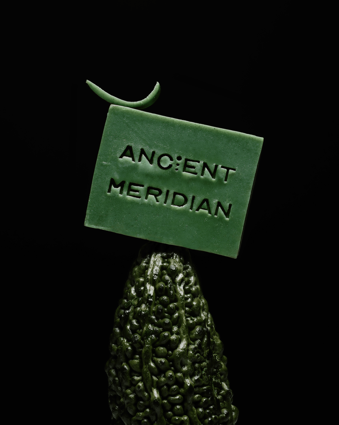 Ancient Meridian Waffa green soap brick styled on natural surface – detoxifying botanical bar soap with grapefruit and rose geranium, Here & Always.